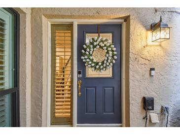 Charming front door adorned with a floral wreath, offering a warm welcome to visitors and enhancing curb appeal at 4222 Hartwood Ln # 1202, Tampa, FL 33618