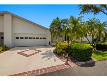Well-maintained home exterior showcasing a driveway, garage, and lush landscaping for curb appeal at 1416 Leland Dr # 49, Sun City Center, FL 33573