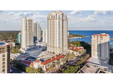 Upscale condo building showcasing waterfront views, mature landscaping, and beautiful red tile roofs at 300 Beach Ne Dr # 401, St Petersburg, FL 33701