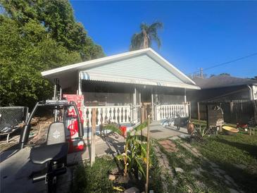Charming single story home with a covered front porch and home gym at 8203 N Semmes St, Tampa, FL 33604