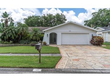 Charming single-story home with a well-maintained lawn and attractive stone driveway, showcasing curb appeal at 1313 Markley Dr, Largo, FL 33770