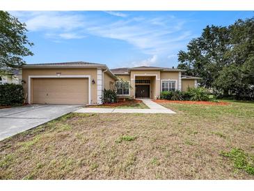 Charming single-story home featuring a well-maintained lawn and two car garage in a desirable location at 14042 Marlberry Way, Odessa, FL 33556