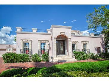 Elegant home featuring a brick walkway, decorative windows and metal balcony details at 1515 Park N St, St Petersburg, FL 33710