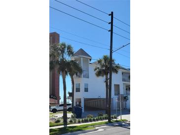 Bright exterior showcasing the coastal design with a peek-a-boo garage and private balconies at 17960 Gulf Blvd # 101, Redington Shores, FL 33708