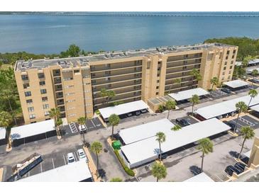 Stunning aerial view of the building, parking, waterfront, and bridge at 2617 Cove Cay Dr # 206, Clearwater, FL 33760