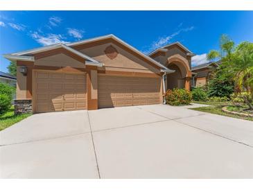Charming single-story home with a well-manicured lawn, a spacious driveway, and a two-car garage at 2637 Yukon Cliff Dr, Ruskin, FL 33570