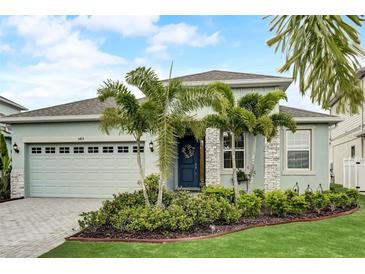 Charming home featuring a beautiful front yard, lush landscaping, and a welcoming entrance at 5413 Wishing Arch Dr, Apollo Beach, FL 33572
