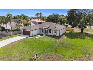 Charming single-story home featuring a well-manicured lawn and inviting walkway to the front door at 9416 Bullfrog Court, Gibsonton, FL 33534