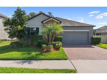 Charming single-Gathering home with well-manicured lawn, brick driveway and 2-car garage at 4690 Coachford Dr, Wesley Chapel, FL 33543