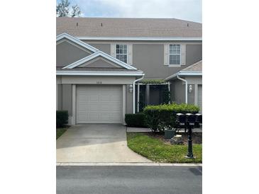 Charming townhome with a one car garage and a well manicured lawn and mature landscaping at 7838 66Th N Way, Pinellas Park, FL 33781
