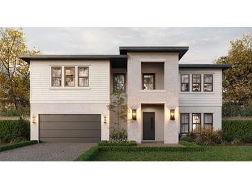 Stunning two-story home with brick and white siding, complemented by professional landscaping and an attached garage at 811 W Ohio Ave, Tampa, FL 33603
