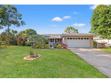 Charming home with a well-manicured front yard, lush landscaping, and a two-car garage, creating curb appeal at 2701 65Th Ave S, St Petersburg, FL 33712
