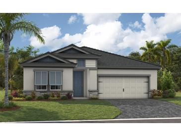 Charming single-story home featuring a well-manicured lawn, palm trees and an attached two car garage at 3923 Farm Garden Ct, Bradenton, FL 34211