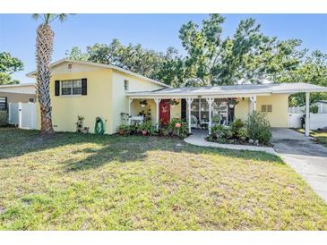 Charming single-story home with mature trees, a well-kept lawn, and a welcoming front porch at 4509 S Cortez Ave, Tampa, FL 33611