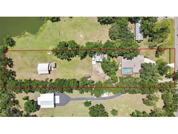 Expansive property with a serene pond, spacious main house with pool, and versatile outbuildings offering ample space at 4706 Scott Rd, Lutz, FL 33558