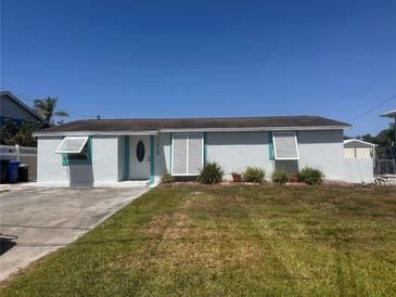 Charming single-story home with a well-maintained lawn and bright white exterior at 825 Seabreeze Dr, Ruskin, FL 33570