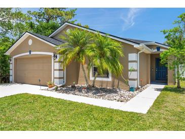 Charming single-story home with a well-maintained lawn, decorative rock garden, and welcoming curb appeal at 8504 Tidal Bay Ln, Tampa, FL 33635