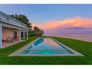 Stunning infinity pool overlooking the ocean and colorful sunset, perfect for relaxing and entertaining at 218 Colony Point S Rd, St Petersburg, FL 33705