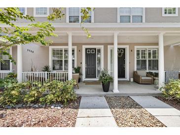 Inviting townhome front porch with stone accents and a neutral color palette at 3702 W Cass St # 5, Tampa, FL 33609