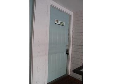 Inviting light blue front door with unit number 201 and secure entry lock at 7927 Kosi Palm Pl # 201, Tampa, FL 33615