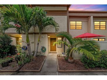 Charming townhome with lush tropical landscaping and a welcoming front entrance at 9209 Seminole Blvd # 156, Seminole, FL 33772