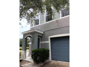 Two-story home featuring a two-tone paint scheme, archway entry, and an attached one-car garage at 1508 Talisker Dr, Clearwater, FL 33755