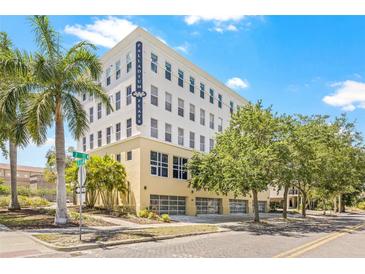 Attractive condominium building, Palladium Flats, featuring clean lines, neutral colors, and beautiful trees at 205 5Th N Ave # 501, St Petersburg, FL 33701