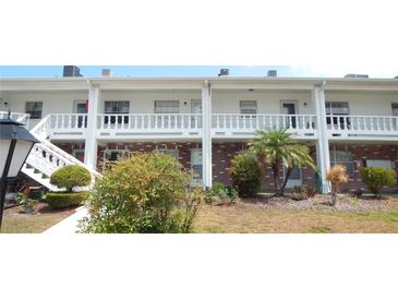 Charming two-story condo with red brick and well-maintained landscaping at 4744 Azalea Dr # 203B, New Port Richey, FL 34652