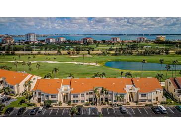 Wide aerial view showcasing community buildings, a golf course and waterfront skyline at 6151 Bahia Del Mar Blvd # 126, St Petersburg, FL 33715