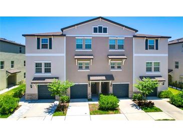 Inviting exterior of a multi-Gathering home, featuring a private garage and well-maintained landscaping at 842 Tennyson Mill Cir, Tampa, FL 33619