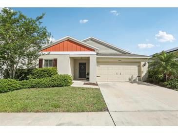 Charming single-story home with a well-manicured lawn, complemented by a two car garage and a welcoming front porch at 12830 Bent Twig Dr, Riverview, FL 33579