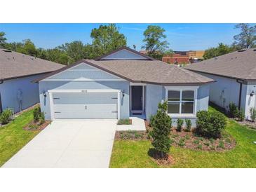Charming single-story home with a well-manicured lawn and an attached two-car garage at 4303 Big Sky Dr, Spring Hill, FL 34604