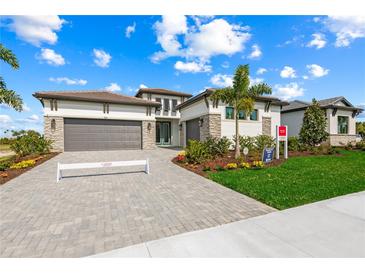 Beautiful single-Gathering home with a lush lawn, large driveway, and a two-car garage at 8913 Bernini Pl, Sarasota, FL 34240