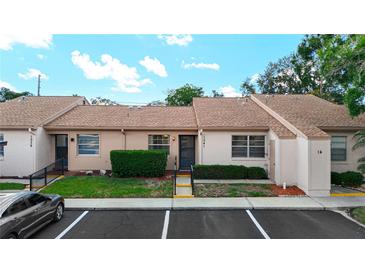 Inviting townhouse with tidy landscaping, beige stucco, and convenient parking at 1041 Bowsprit Ln # 1041, Holiday, FL 34691