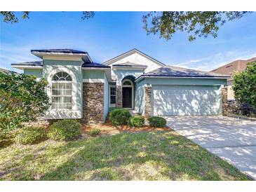 Charming one-story home featuring stone accents, manicured landscaping, and an attached two-car garage at 11567 Weston Course Loop, Riverview, FL 33579