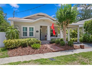 Charming single-story home featuring a brick walkway, covered porch, and beautiful landscaping at 3620 W San Pedro St, Tampa, FL 33629