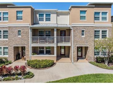 Charming townhouse with brick accents, dual balconies and well-maintained landscaping at 1543 W Cass St, Tampa, FL 33606