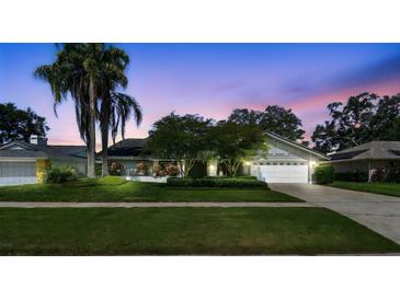 Charming single-story home boasting mature landscaping and a well-manicured lawn at twilight at 1622 El Tair Trl, Clearwater, FL 33765