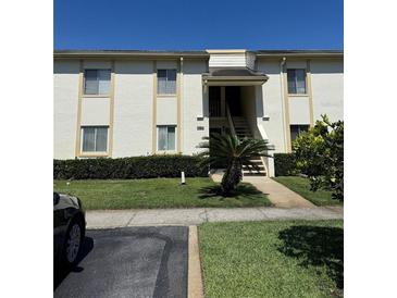 Inviting two-story condo building featuring well-maintained landscaping and a charming entrance at 210 Cypress Ct # 122, Oldsmar, FL 34677
