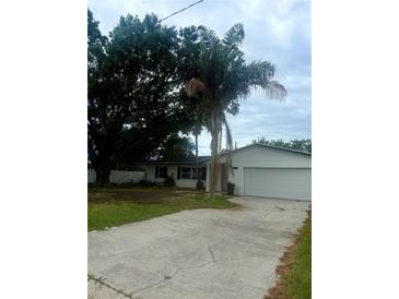 Charming single-story home with a well-manicured lawn and a two-car garage at 4824 Huntington Ne St, St Petersburg, FL 33703