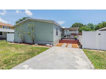 Charming single-story home featuring a well-maintained lawn and welcoming walkway leading to a covered entry at 6036 110Th N Ave, Pinellas Park, FL 33782