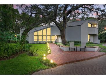 Stunning exterior view featuring brick pathway, modern architecture, and lush landscaping at 14825 Lake Magdalene Cir, Tampa, FL 33613