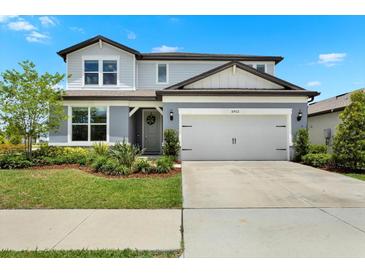 Charming two-story home featuring a two-car garage and well-maintained landscaping at 3952 Almond Brook Blvd, Land O Lakes, FL 34638