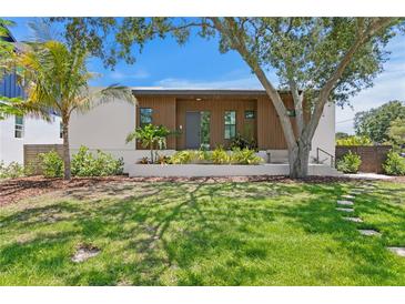 Inviting modern home with wood accents, mature trees, and lush landscaping at 500 38Th Ne Ave, St Petersburg, FL 33704