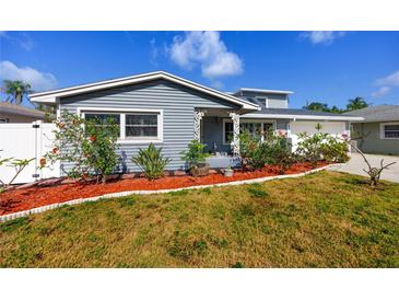Charming single Gathering home featuring fresh landscaping, including red mulch and tropical plants at 6536 115Th Ln, Seminole, FL 33772