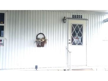 Clean and well-maintained exterior with a white front door, basket, and clear address numbers at 37648 Campo Ave, Zephyrhills, FL 33541