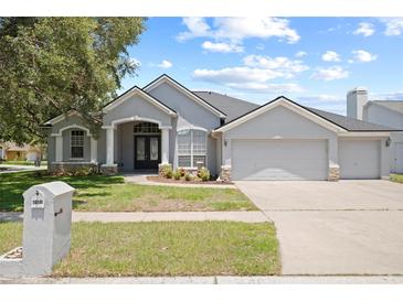 Charming single-story home with a well-manicured lawn and a three car garage at 4401 Arranmore Cir, Valrico, FL 33596
