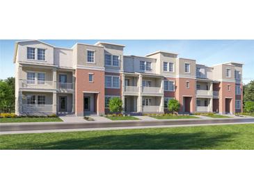 Charming townhome exterior with brick facade, white balconies, and well-manicured landscaping at 4511 S Manhattan Ave # 13, Tampa, FL 33611