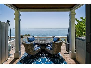 Outdoor patio showcasing a table and chairs, providing a relaxing space with an ocean view at 5042 Coquina Key Se Dr, St Petersburg, FL 33705
