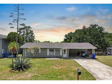 Charming single story home boasts a well-maintained lawn, mature landscaping and a covered carport at 6208 Florida E Cir, Apollo Beach, FL 33572